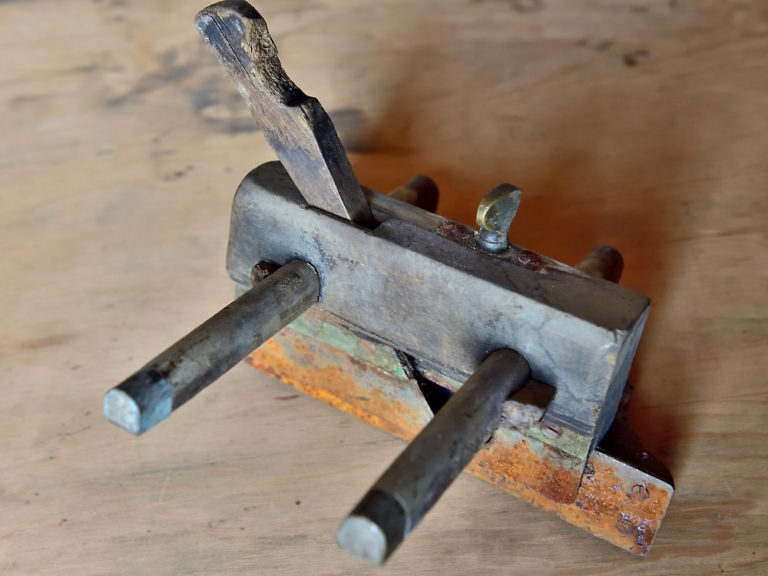 Wooden plough plane in poor state.