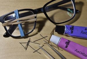 Broken glasses frame with repair items
