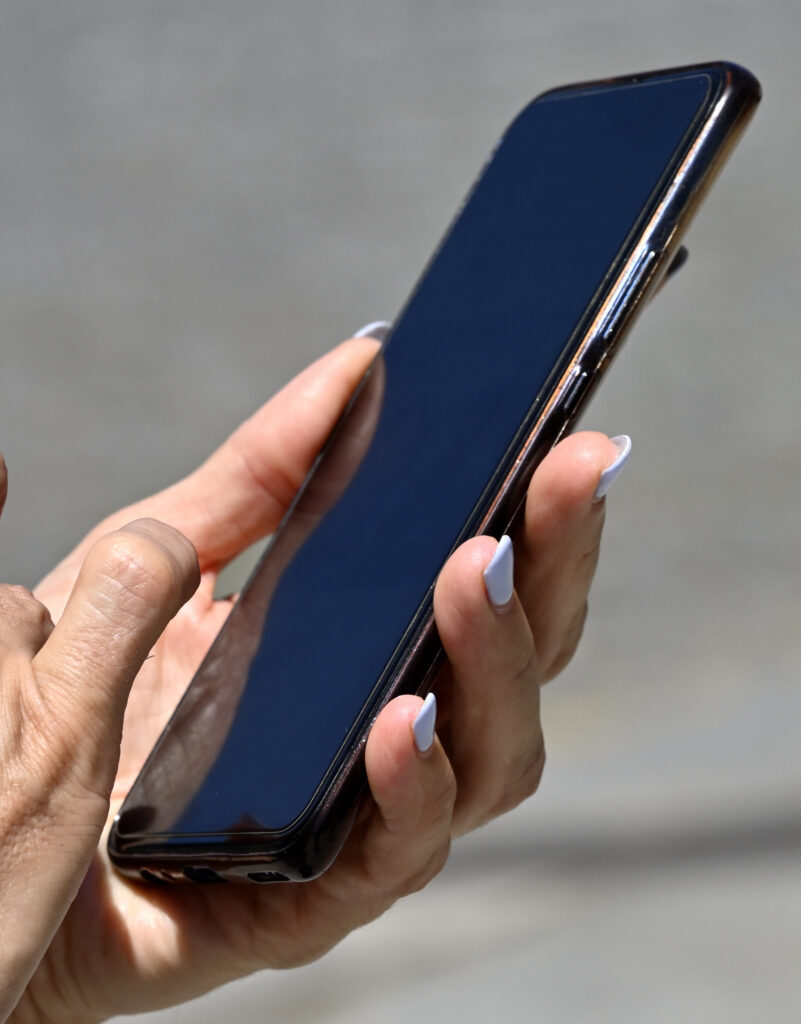 Hands holding smart phone useful in emergency